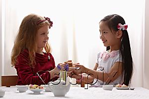 AsiaPix - two young girls having a tea party