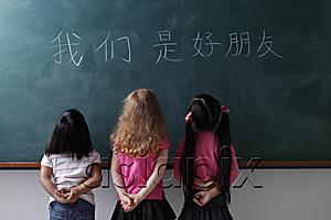 AsiaPix - three young girls looking at Chinese characters 