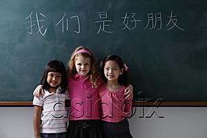 AsiaPix - three young girls in front of chalk boards with Chinese writing 