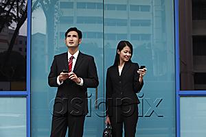 AsiaPix - man and woman wearing suites and holding phones