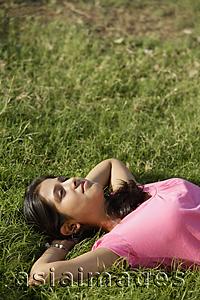 Asia Images Group - teen girl lying on back on grass