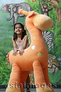 Asia Images Group - little girl with big stuffed giraffe