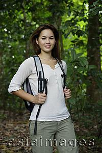 Asia Images Group - Woman with backpack in the woods