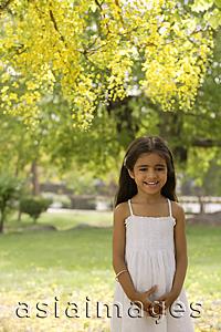 Asia Images Group - little girl standing under tree