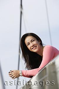 Asia Images Group - Young woman leaning over bridge