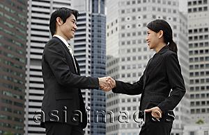 Asia Images Group - Profile of two business colleagues shaking hands