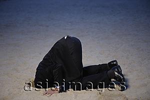 Asia Images Group - Businessman with head buried in sand