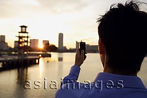 Asia Images Group - Back view of young man with mobile phone