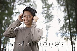 Asia Images Group - Man listening to head set