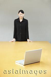 Asia Images Group - businesswoman staring at laptop on conference table