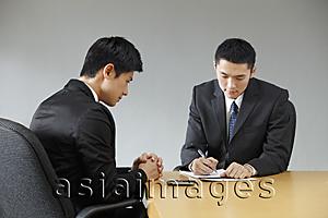 Asia Images Group - two businessmen having a meeting