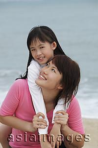 Asia Images Group - girl with arms around young woman