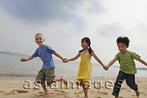 Asia Images Group - Three children running while holding hands.