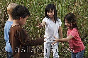 Asia Images Group - Four children playing outside.