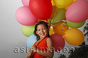 Asia Images Group - Smiling girl holding balloons.