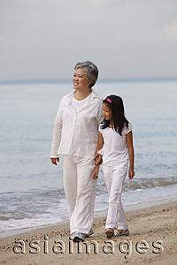 Asia Images Group - Older woman walking with young girl.
