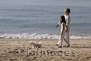 Asia Images Group - Older woman walking dog with young girl.