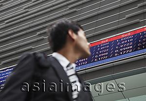 Asia Images Group - businessman in a suit looking at stock exchange