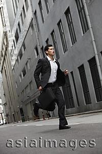 Asia Images Group - businessman running down street