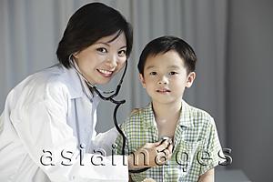 Asia Images Group - Doctor giving a young boy a check up