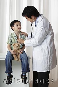Asia Images Group - Doctor listening to young boy's heart