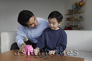 Asia Images Group - Father talking to young son about finances