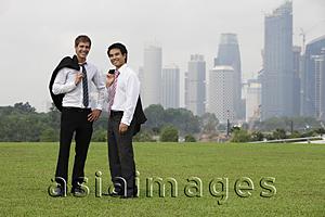 Asia Images Group - Two men holding their jackets over their shoulders outside
