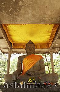 Asia Images Group - stone carving of Buddha wearing orange sash, Angkor Wat