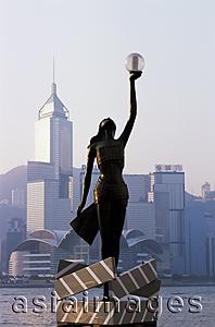 Asia Images Group - China,Hong Kong,Kowloon,Tsim Sha Tsui,Avenue of the Stars,Bronze Statue with City Skyline in the Background