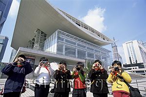 Asia Images Group - China,Shanghai,Children Taking Photoes in front of Shanghai Grand Theatre in People's Square