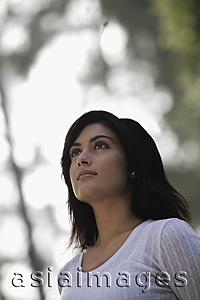 Asia Images Group - Head shot of young woman looking up to the sky