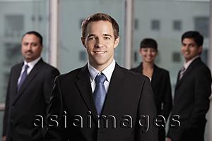 Asia Images Group - caucasian man standing in front of colleagues