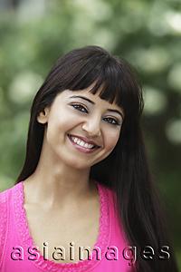 Asia Images Group - Head shot of young woman with long hair smiling.