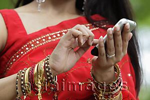 Asia Images Group - Close up of Indian woman texting on phone