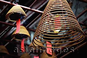 Asia Images Group - Incense coils hanging from temple ceiling.