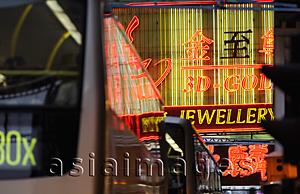 Asia Images Group - Neon signs with bus in foreground