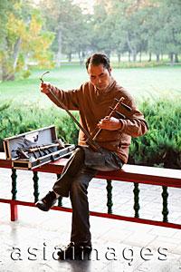 Asia Images Group - China,Beijing,Temple of Heaven Park,Man Playing Erdu Traditional Stringed Instrument