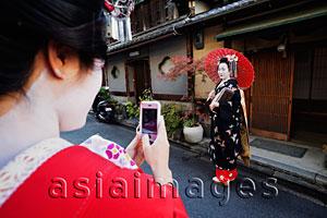 Asia Images Group - Woman taking photo of Geisha dressed up in traditional Japanese clothes