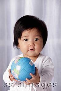 Asia Images Group - Head shot of Chinese baby holding small globe