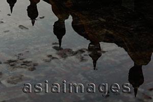 Asia Images Group - Reflection of stone Buddhas in water
