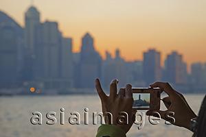 Asia Images Group - Woman Taking Photo of City Skyline and Victoria Peak. Hong Kong, China