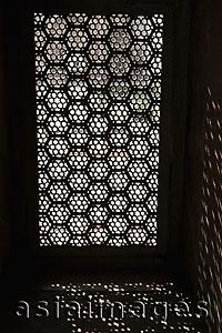Asia Images Group - Light coming through a carved screen window . Agra, India