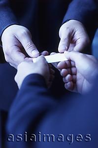 Asia Images Group - Hands exchanging business card, close up