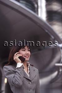 Asia Images Group - Female executive using cellular phone