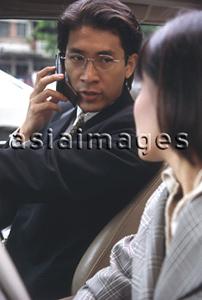 Asia Images Group - Male executive in car talking on cellular phone