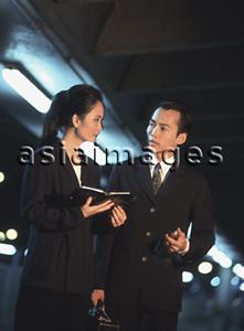 Asia Images Group - Two executives talking at night