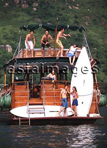 Asia Images Group - Group of teenagers on yacht , doing funny poses
