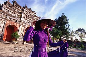 Asia Images Group - Vietnam, Hue, the Citadel,  woman in traditional Vietnamese dress