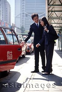 Asia Images Group - Two executives getting into taxi