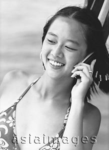 Asia Images Group - Teen girl talking on cellular phone, smiling